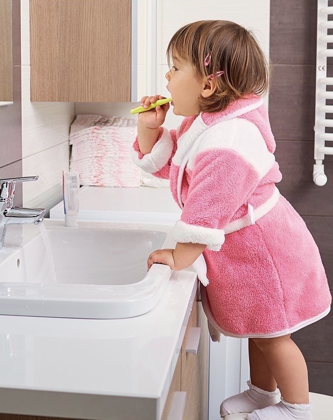 toddler brushing her teeth