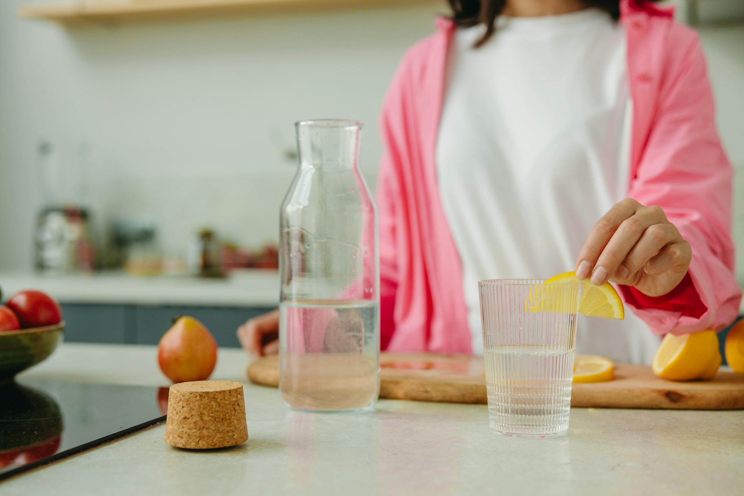 A glass of fresh water with lemon slices
